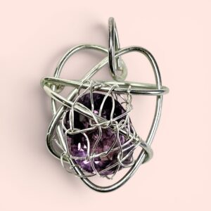 Amethyst faceted oval gemstone set in a silver wire heart.